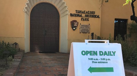 sandwich board sign in front of visitor center door reading 