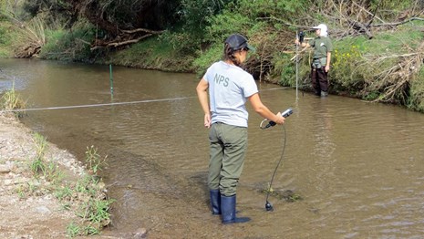 NPS staff with monitoring equipment in the Santa Cruz river