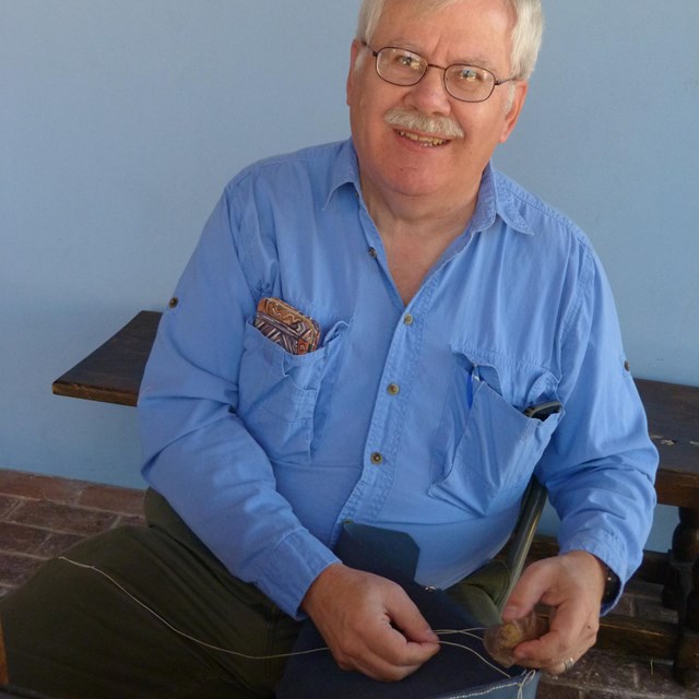 man holding leather and laces