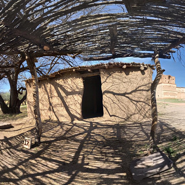 spherical panoramic photo of earthen house with brush ramada