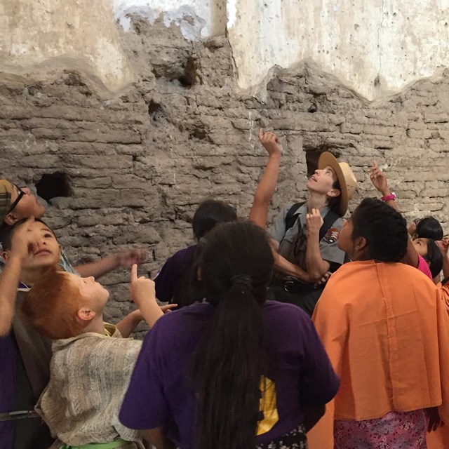 students pointing at ceiling inside the church