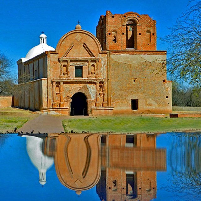Photograph of adobe church reflected in a table top