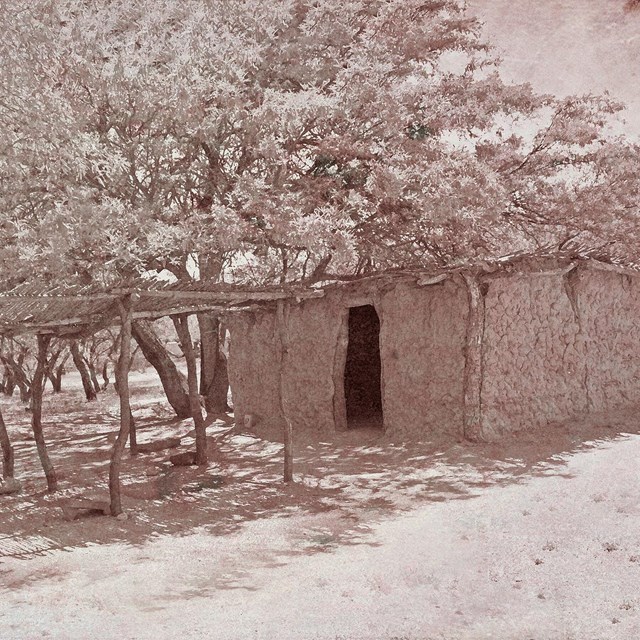 Sepia tone image of mud house.