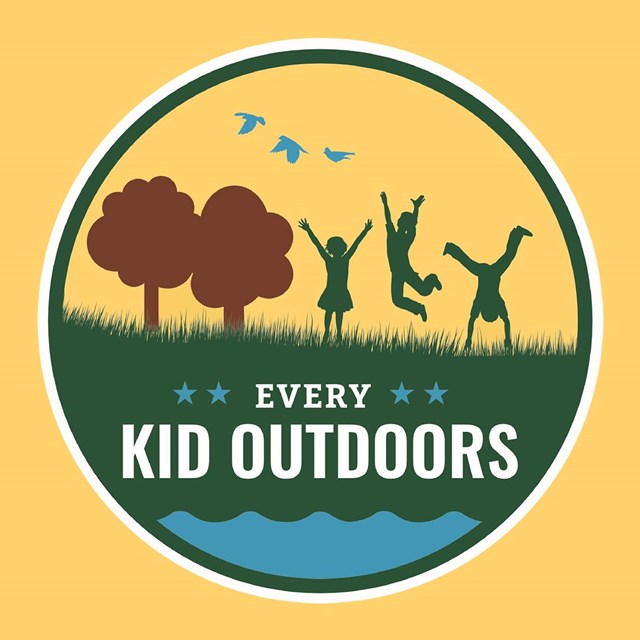 logo of Every Kid Outdoor with kids playing on grassy field with trees and birds in the sky