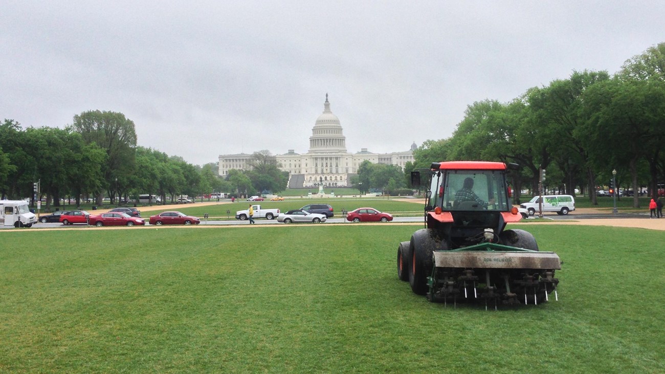 a red tractor in front of the US capitol building
