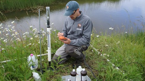 A network employee calibrating water quality instruments