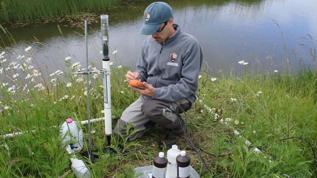 A network employee calibrating water quality instruments