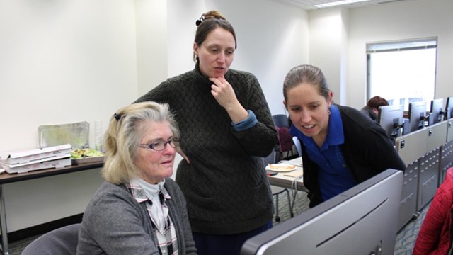 Three women of different ages using a computer.