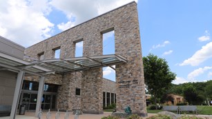 Photograph of the exterior of Howard County Library - a two store stone structure.