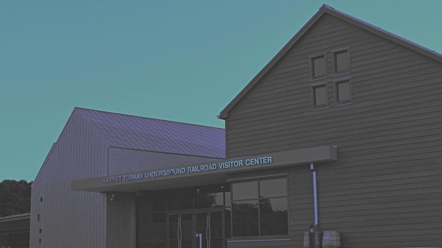 A photograph of the Harriet Tubman Underground Railroad Visitor Center with a blue monochrome filter