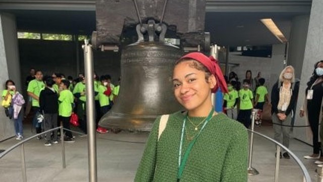 Photograph of intern Jada posing in front of the Liberty Bell in Philadelphia