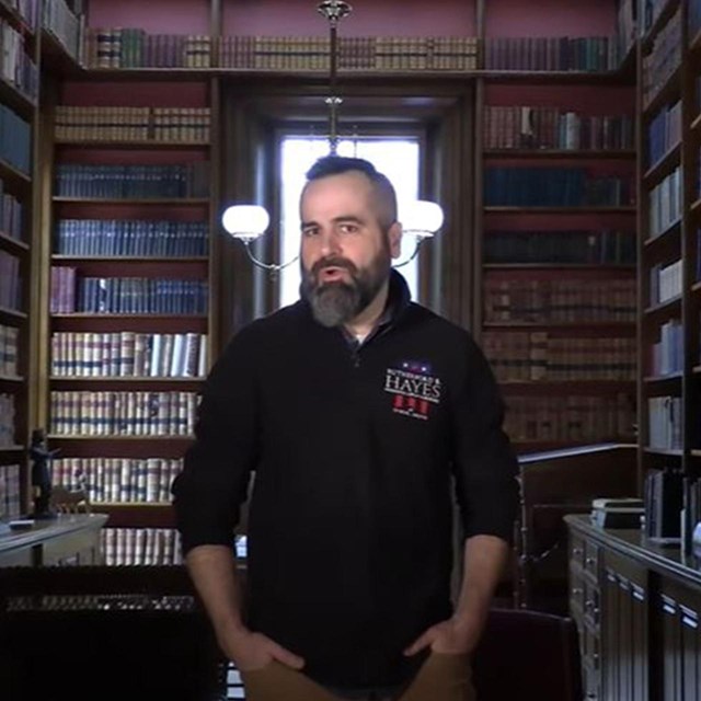 Historian Dustin McLochlin stands in a historic library.