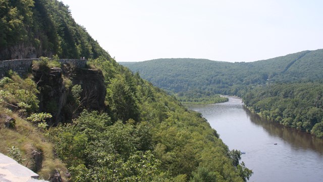 View of river from high vantage point. On left is mountain with road.