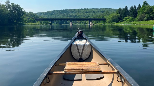 First person POV from canoe, looking out on river.