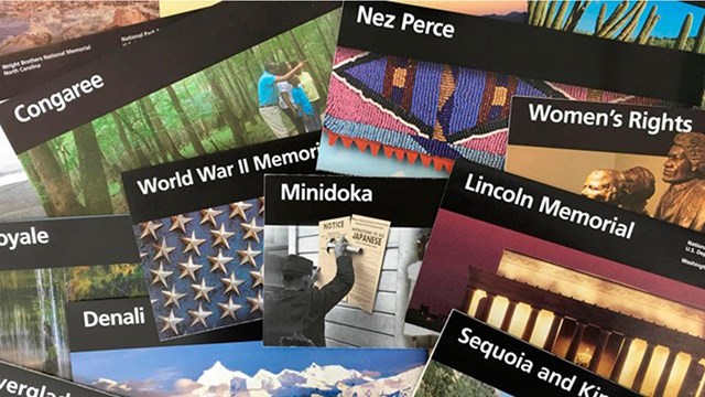 Different unigrid brochures with the iconic black band spread out over each other