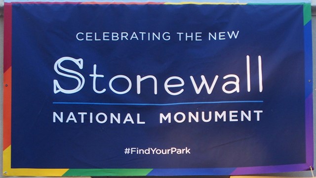 Blue Stonewall National Monument banner hanging on the outside wall of the Stonewall Inn