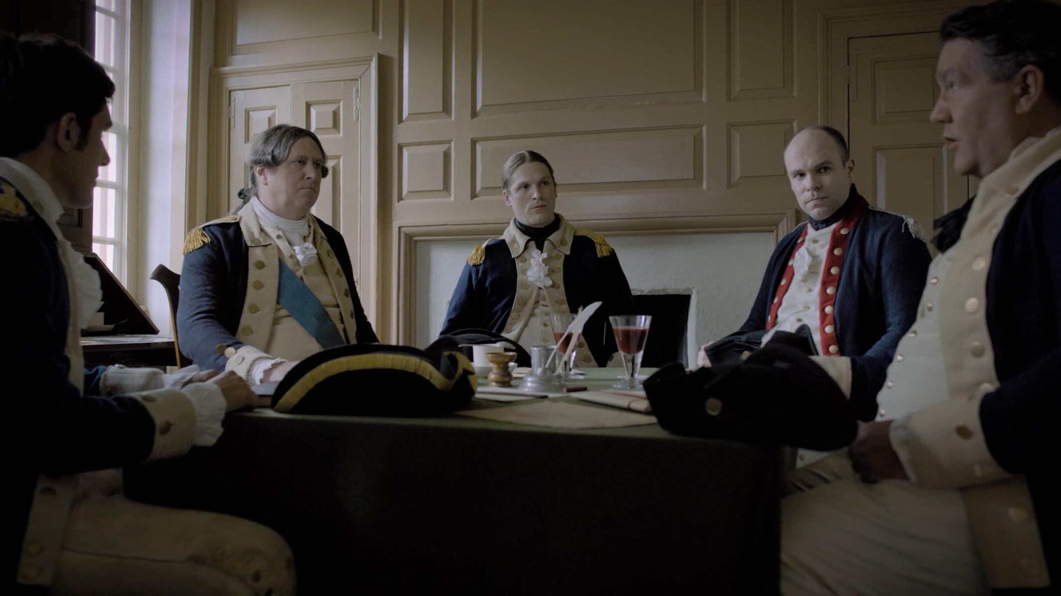 Photo of General Washington and others seated around a table.