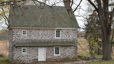 A stone building surrounded by trees where James Varnum stayed. 