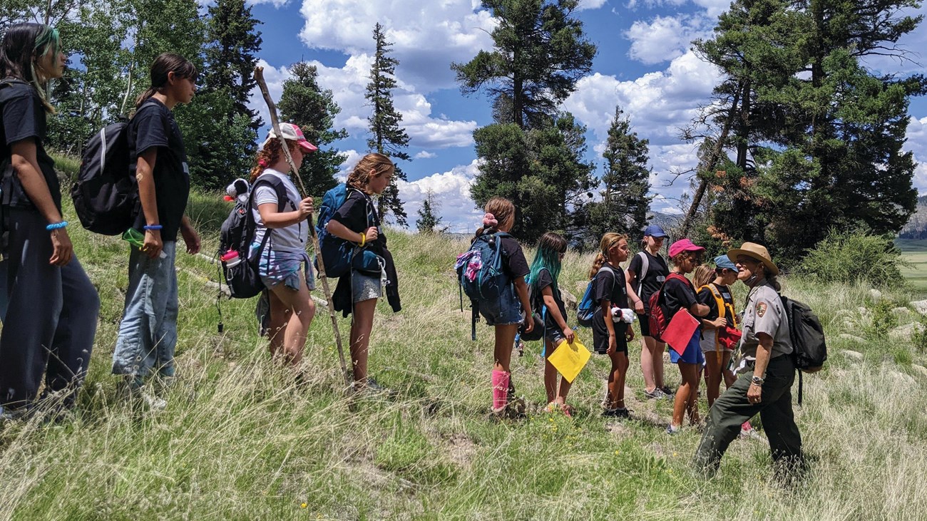 A ranger talking with a group of female students