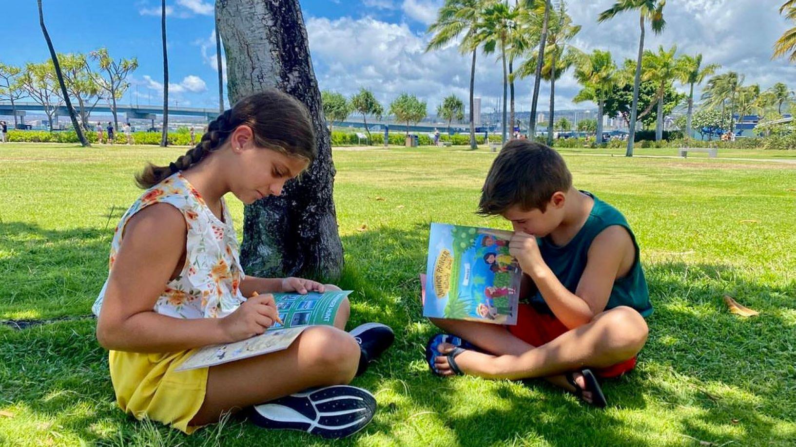 Two children complete Jr ranger books