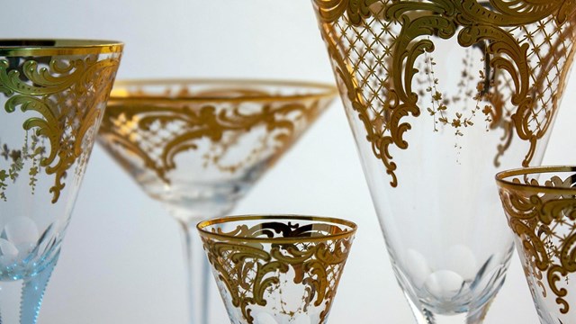 A collection of gilded glass goblets in various sizes.