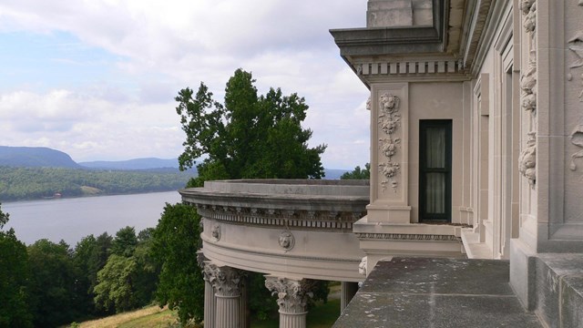 A limestone mansion overlooking a river.