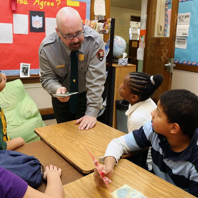 A park ranger talks to kids in a classroom