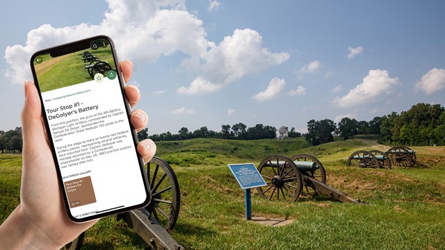 A phone held up with information about a location within the park