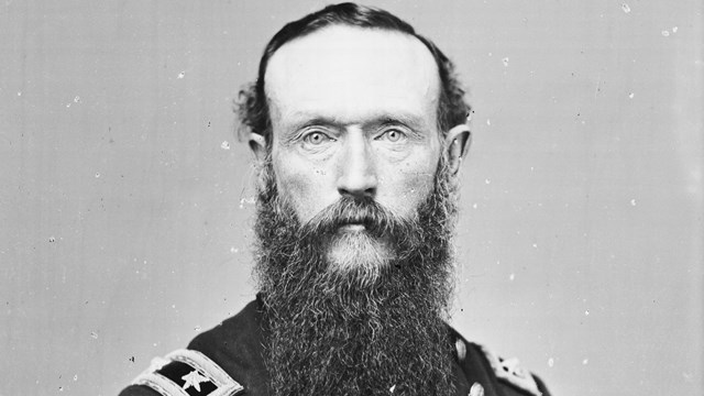 A black and white image of Frederick Steele standing looking with clear blue eyes and pale skin.