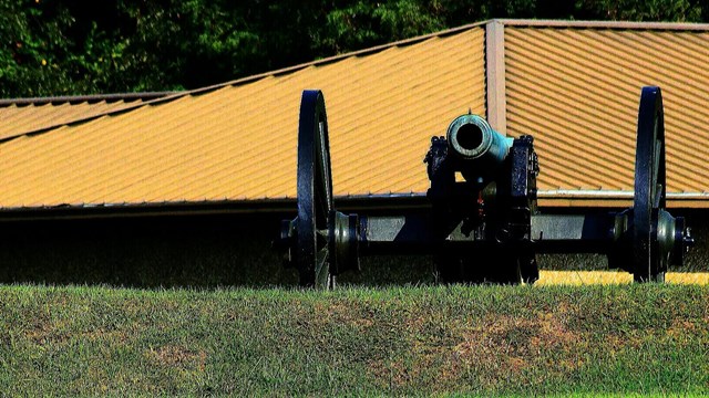 Entrance sign with civil war cannon