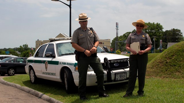 rangers in front of a patrol car