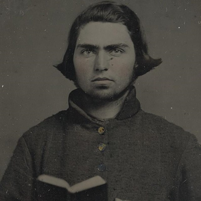 A Confederate from Kentucky holding a open book.