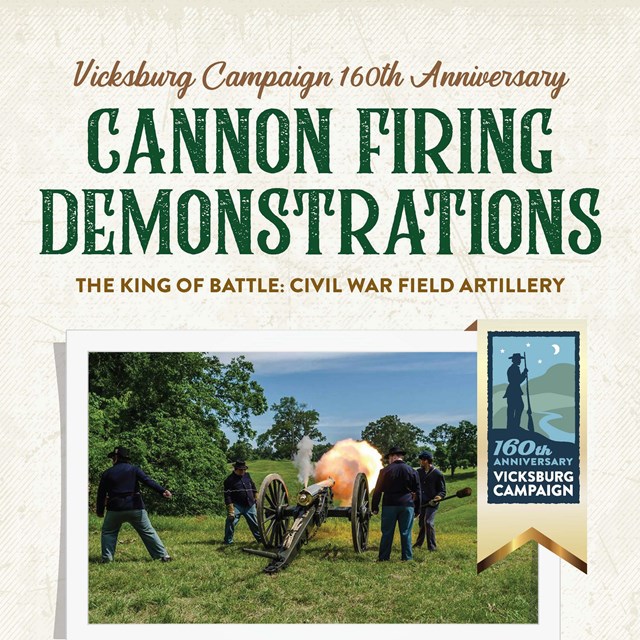 Four people in blue uniforms firing a shiny bronze cannon on a wheeled carriage.