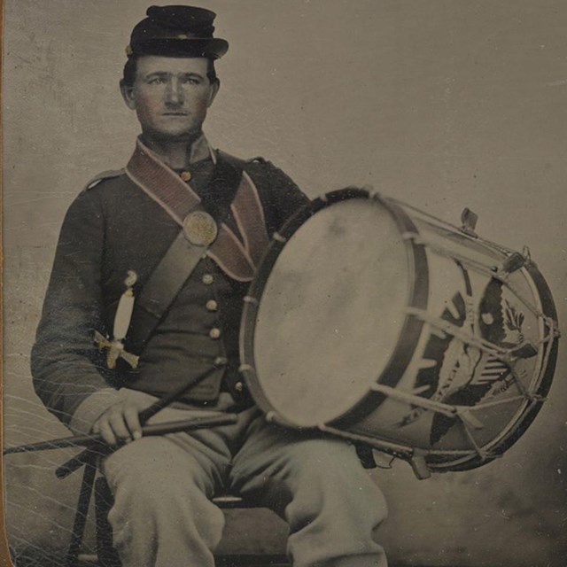 A Union drummer boy holding his drum.