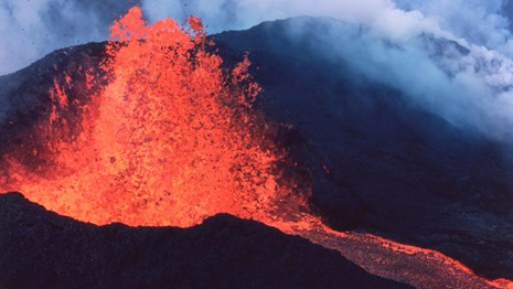 photo of volcanic eruption with lava curtain