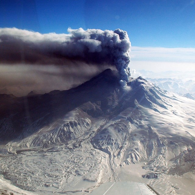 view of erupting volcano with ash cloud