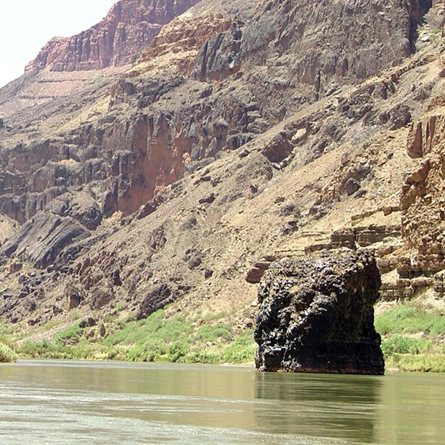 photo of a river and canyon wall