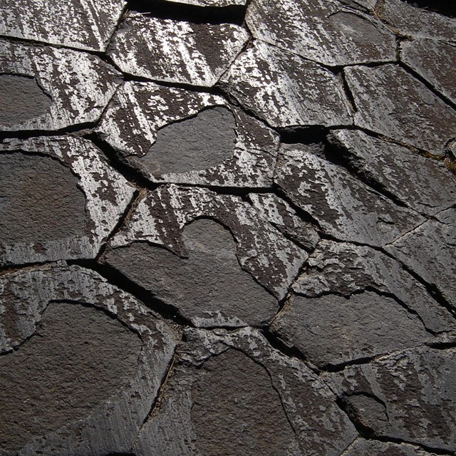 photo of a rock surface with hexagonal jointing and glacial polish/striations