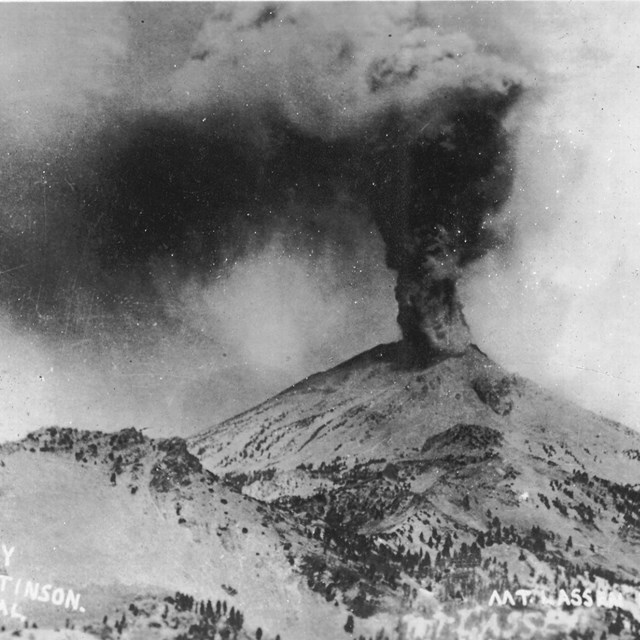 black and white photo of an erupting volcano