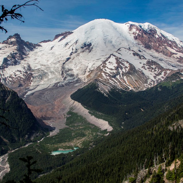 photo of a volcanic mountain with forested slopes