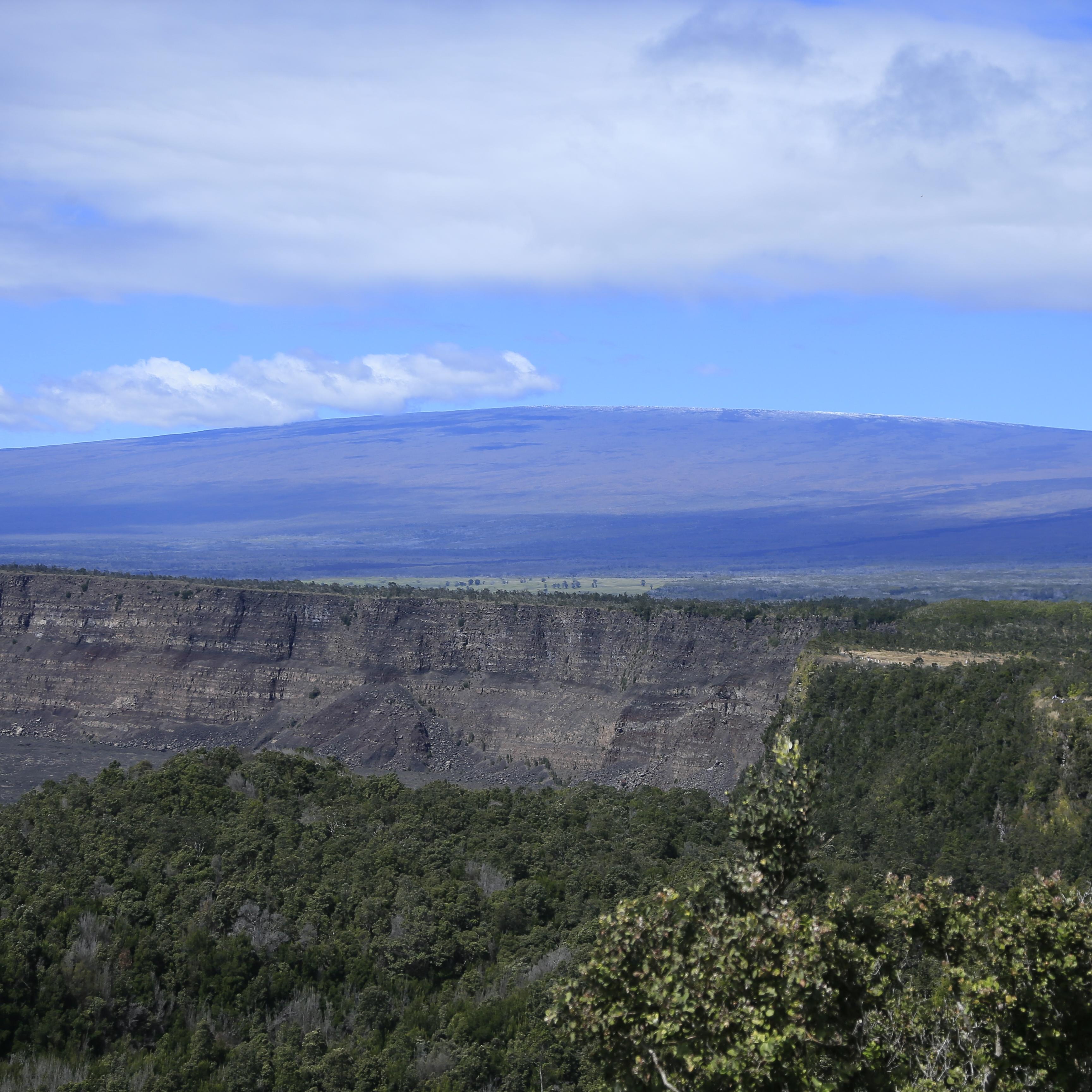 photo of a broad low volcanic mountain in the distance