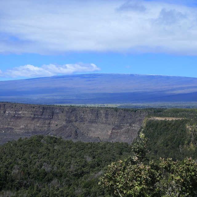 photo of a broad low volcanic mountain in the distance