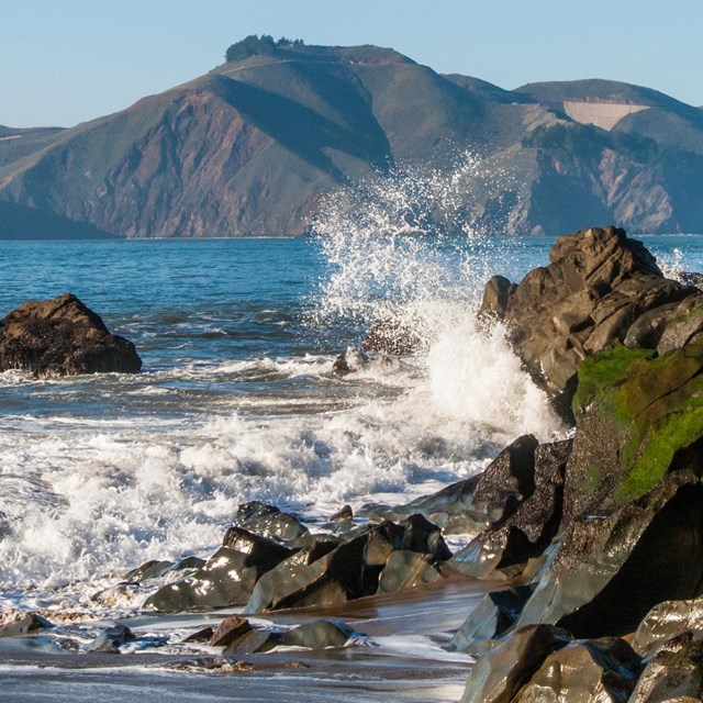waves crashing into a rocky shore