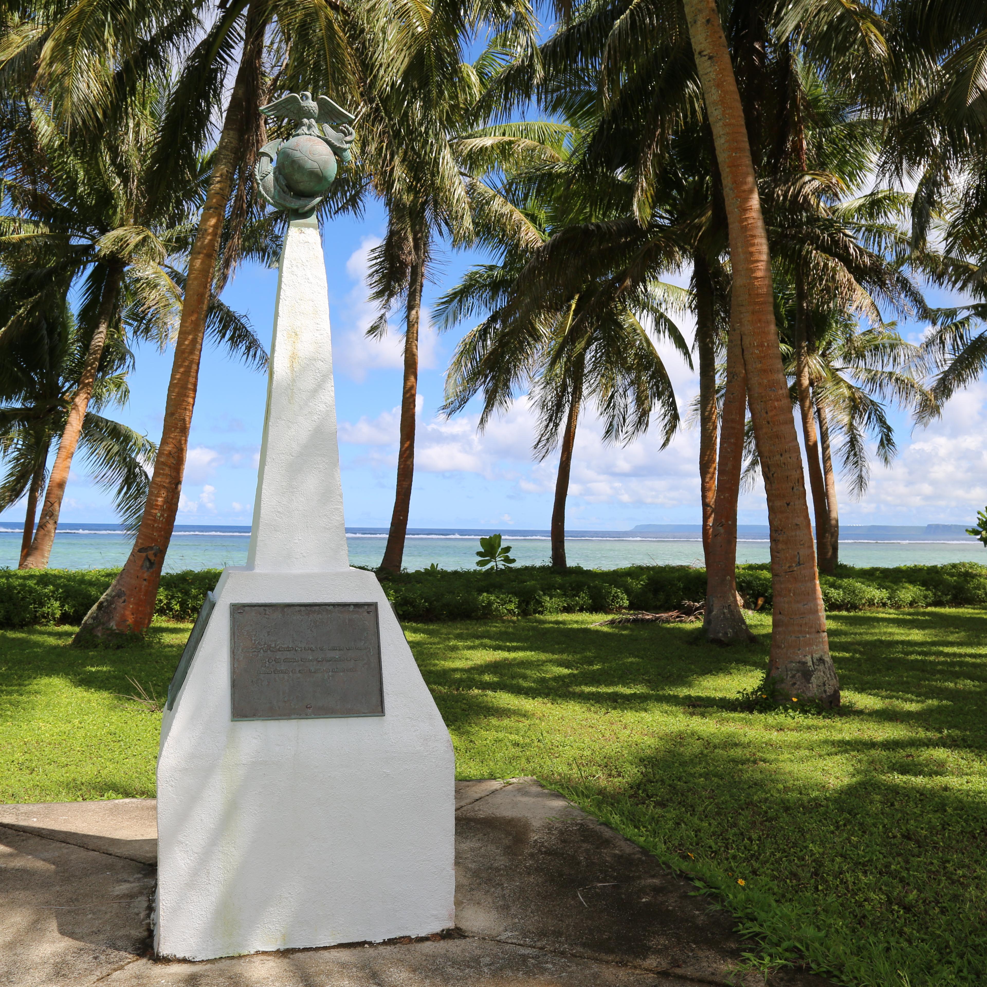 A white obelisk. On the top of it is a ball with an eagle perched on top.