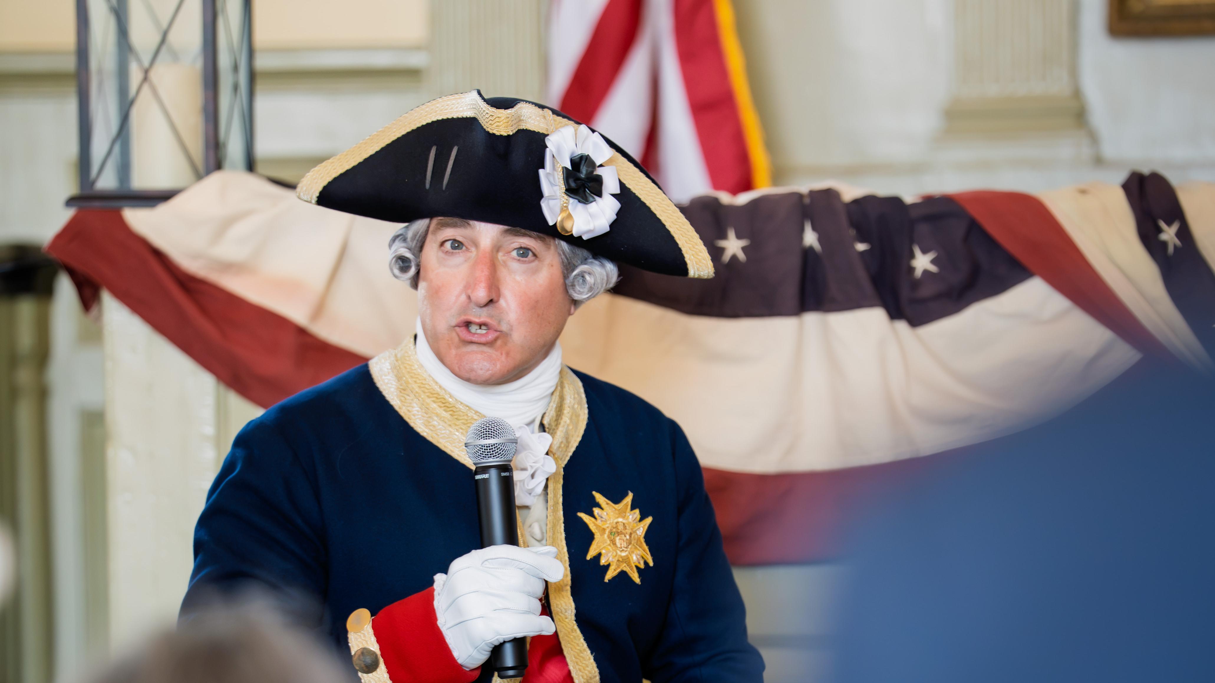 A living history interpreter portraying French General Rochambeau speaks to an audience.