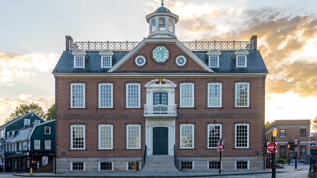 Brick Building on corner with sunset in background
