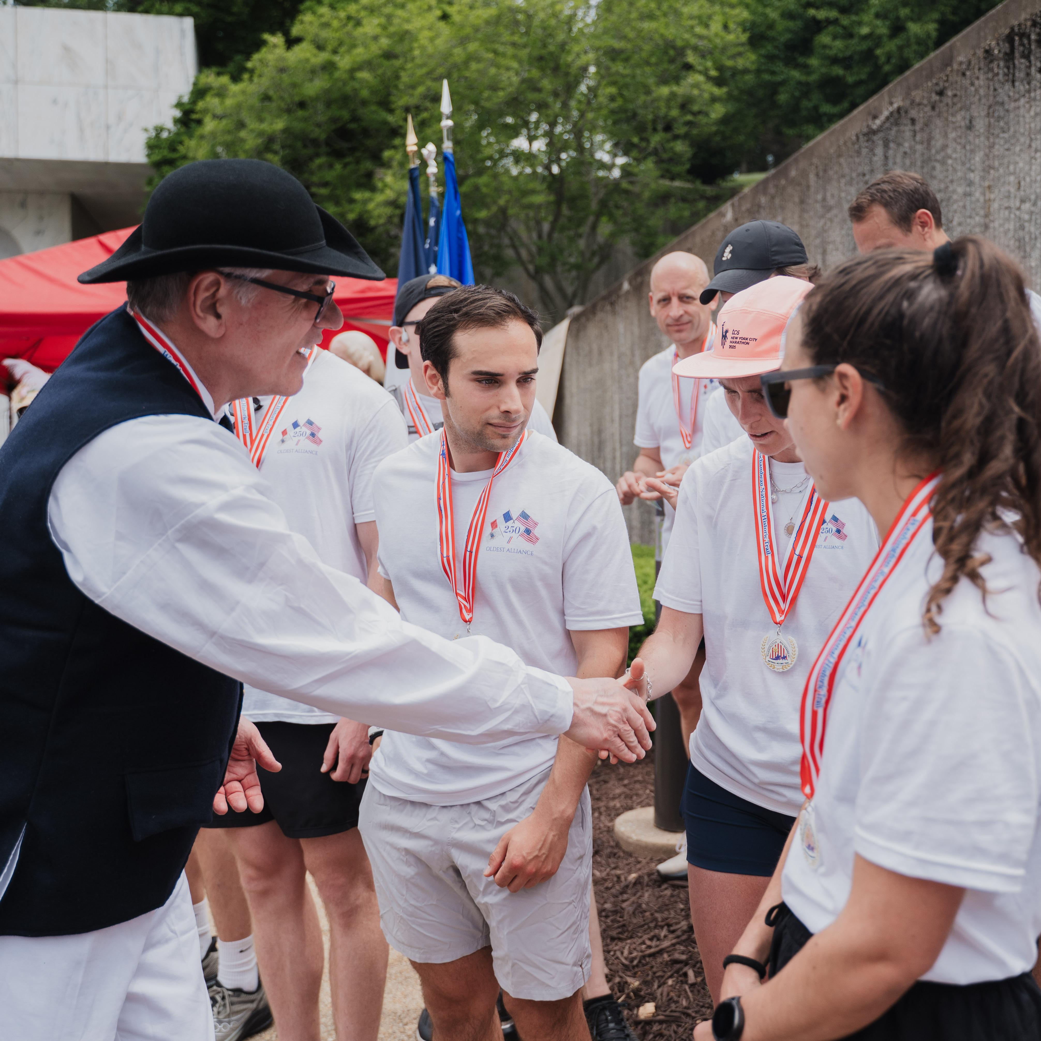 Volunteer passes out trail medals to runners 