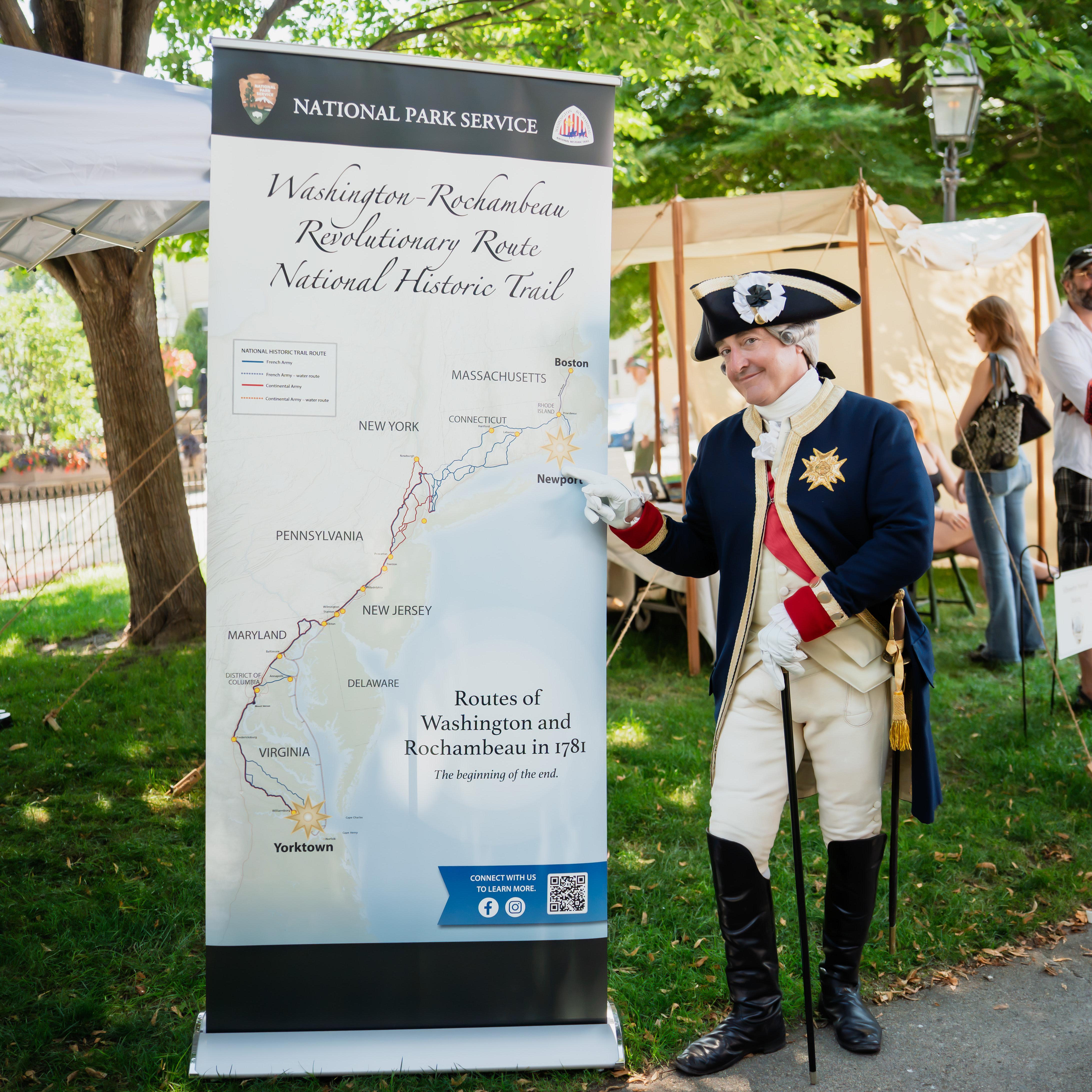 Trail pull up banner map with reenactor standing to right of it