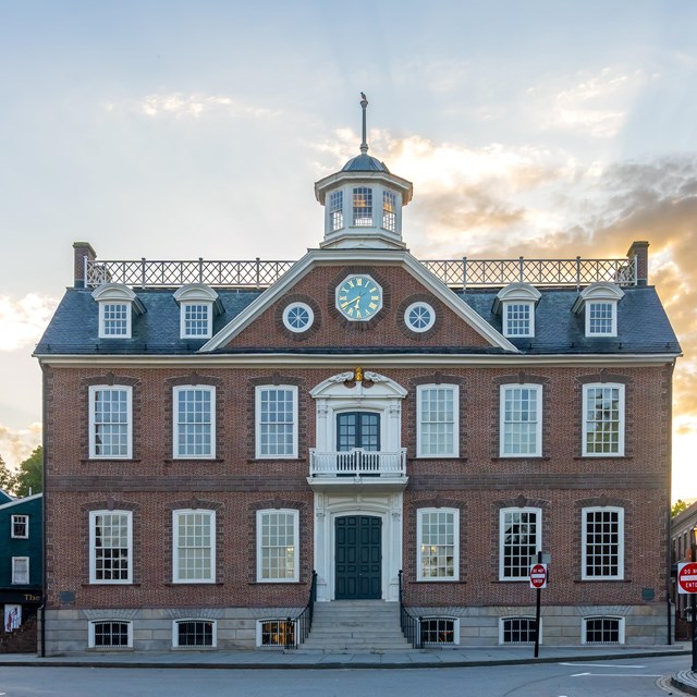 Brick Building on corner with sunset in background