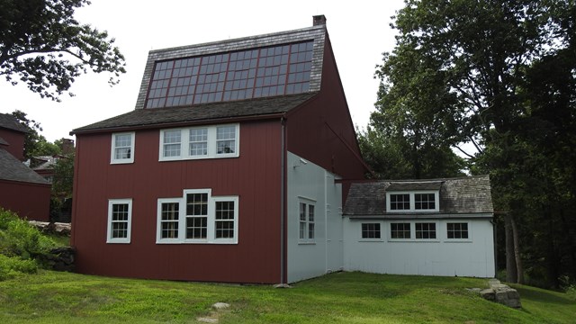 A red building with white trim and several windows.